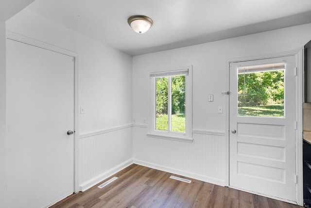 2729 S 52nd St, Kansas City, KS 66106 - doorway to outside with a wainscoted wall and wood finished floors