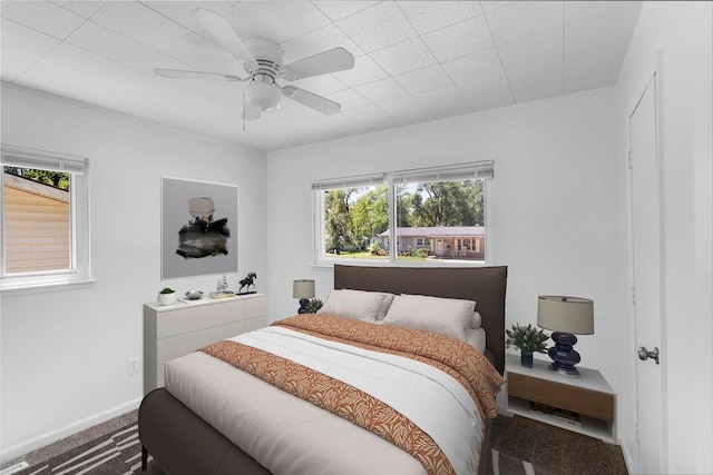 2729 S 52nd St, Kansas City, KS 66106 - bedroom with multiple windows, carpet floors, a ceiling fan, and baseboards