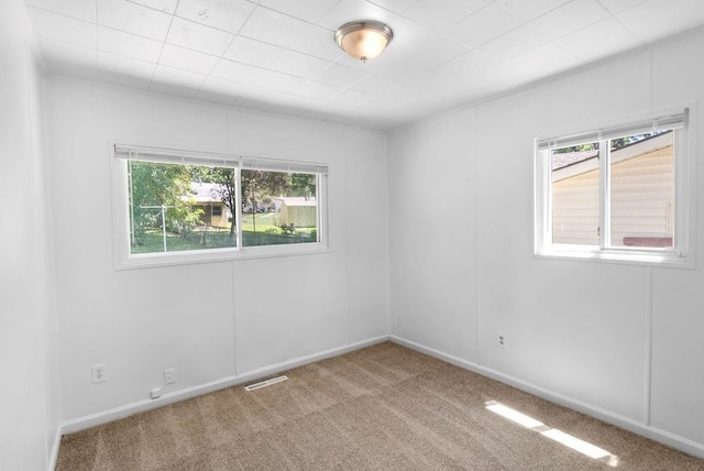 2729 S 52nd St, Kansas City, KS 66106 - carpeted empty room featuring healthy amount of natural light and baseboards