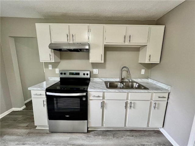 8416 Greenwood Rd, Raytown, MO 64138 - kitchen with stainless steel range with electric stovetop, under cabinet range hood, a sink, light wood-style flooring, and light countertops