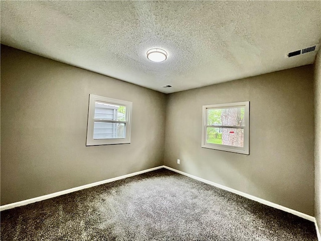 8416 Greenwood Rd, Raytown, MO 64138 - empty room featuring carpet, baseboards, and a textured ceiling