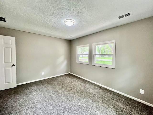 8416 Greenwood Rd, Raytown, MO 64138 - spare room featuring carpet, baseboards, and a textured ceiling