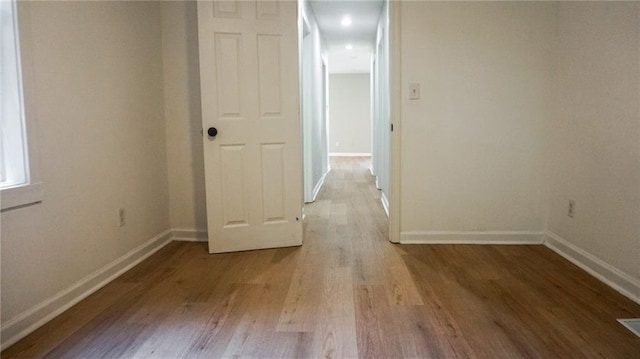 2243 Spruce Ave, Kansas City, MO 64127 - spare room with wood finished floors and baseboards