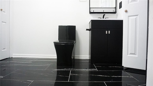 2243 Spruce Ave, Kansas City, MO 64127 - bathroom view of vanity and baseboards