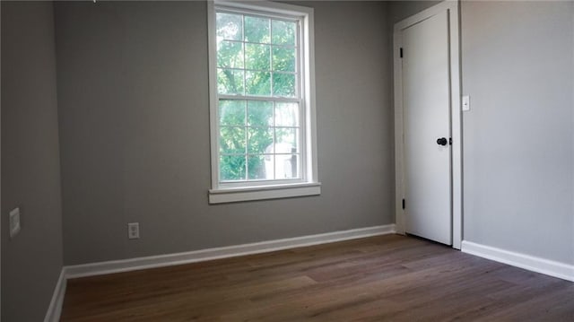 2243 Spruce Ave, Kansas City, MO 64127 - spare room featuring dark wood finished floors and baseboards