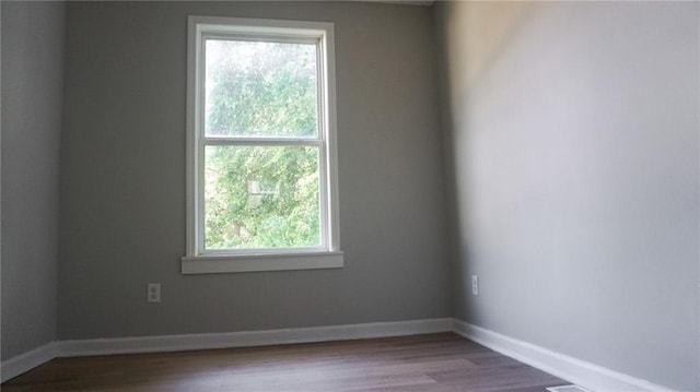 2243 Spruce Ave, Kansas City, MO 64127 - spare room featuring wood finished floors and baseboards