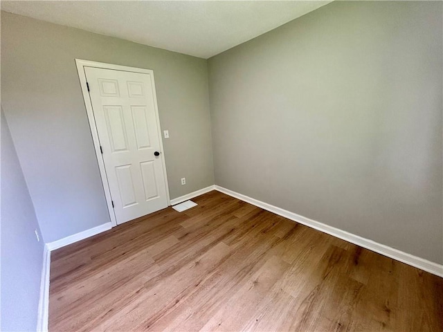2243 Spruce Ave, Kansas City, MO 64127 - spare room with baseboards and wood finished floors