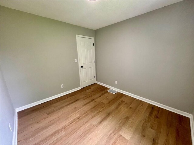 2243 Spruce Ave, Kansas City, MO 64127 - empty room with baseboards and wood finished floors