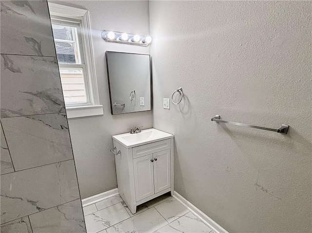 2243 Spruce Ave, Kansas City, MO 64127 - bathroom featuring marble finish flooring, vanity, baseboards, and plenty of natural light
