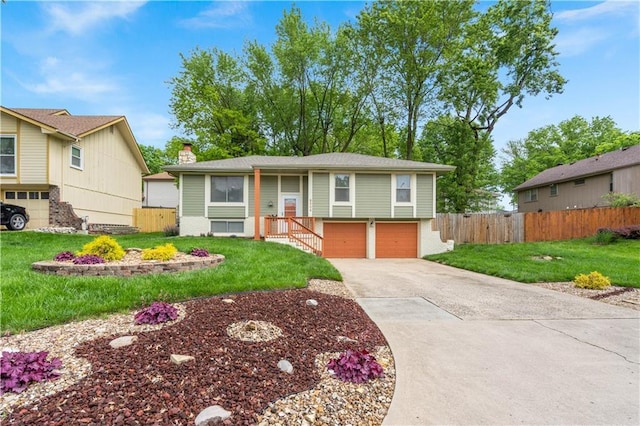 9504 E 89th St, Kansas City, MO 64138 - raised ranch featuring an attached garage, concrete driveway, a chimney, and brick siding
