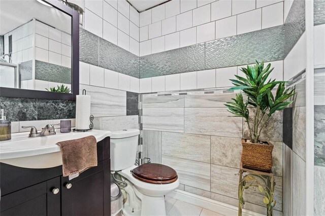 9504 E 89th St, Kansas City, MO 64138 - bathroom with tile walls, toilet, vanity, and tile patterned flooring
