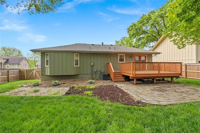 9504 E 89th St, Kansas City, MO 64138 - rear view of house with a deck, a patio, cooling unit, and board and batten siding