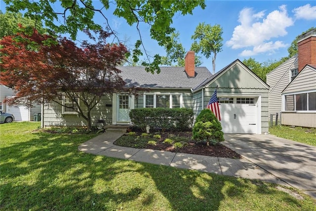 5824 Marty St, Overland Park, KS 66202 - view of front of home featuring a garage, a front lawn, concrete driveway, and a chimney