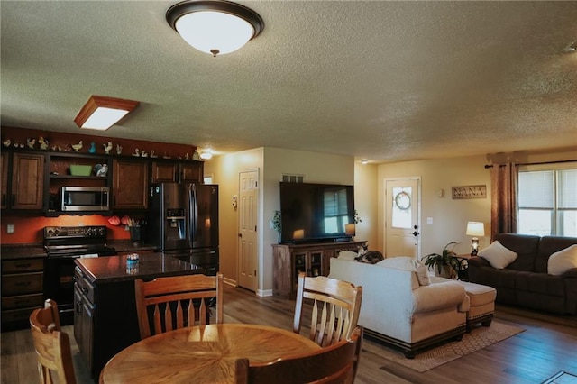 7164 State Route T Hwy, Amazonia, MO 64421 - dining room featuring a textured ceiling and wood finished floors