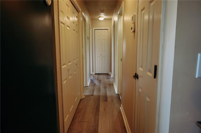 7164 State Route T Hwy, Amazonia, MO 64421 - hall featuring hardwood / wood-style flooring, baseboards, and a textured ceiling
