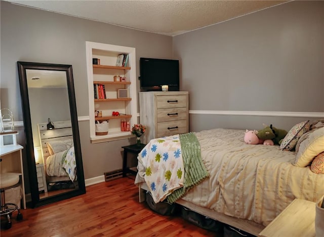 7166 State Route T Hwy, Amazonia, MO 64421 - bedroom featuring wood finished floors and a textured ceiling