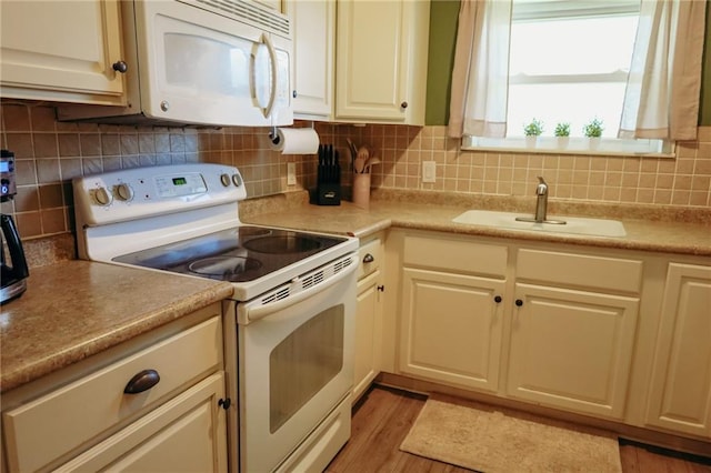7166 State Route T Hwy, Amazonia, MO 64421 - kitchen featuring white appliances, decorative backsplash, light wood finished floors, and light countertops