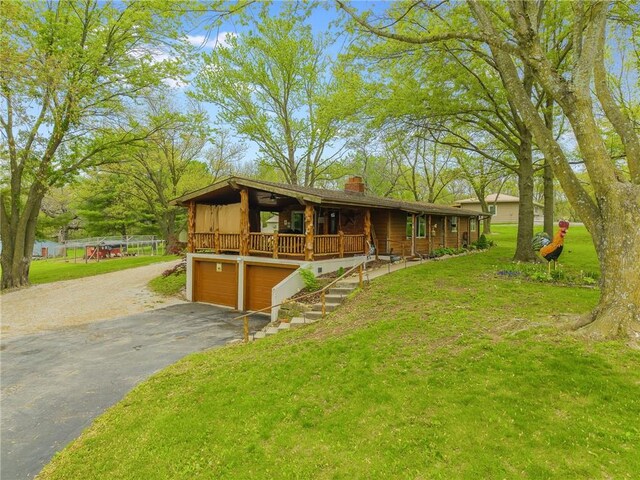13813 Petty Rd, Kearney, MO 64060 - view of front of home with stairway, a chimney, a front yard, and a garage