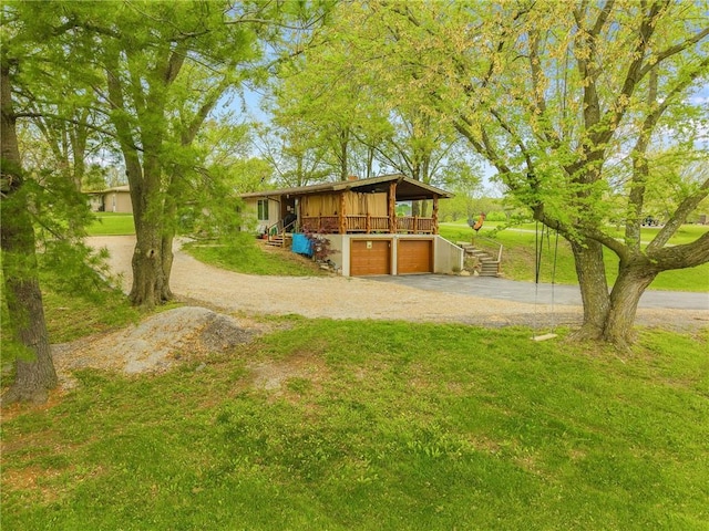 13813 Petty Rd, Kearney, MO 64060 - view of yard with stairway, an attached garage, and driveway