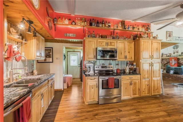 13813 Petty Rd, Kearney, MO 64060 - kitchen with dark wood-style flooring, appliances with stainless steel finishes, a sink, a textured ceiling, and a ceiling fan