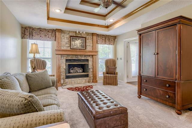 748 SW Windsong Cir, Lees Summit, MO 64082 - living room featuring crown molding, light carpet, a raised ceiling, ceiling fan, and a fireplace