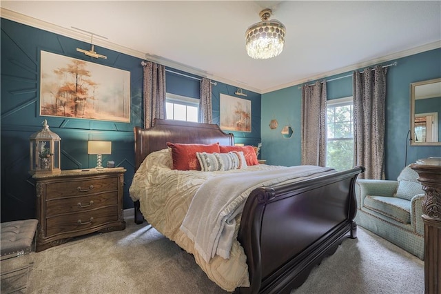 carpeted bedroom featuring crown molding, multiple windows, and a chandelier