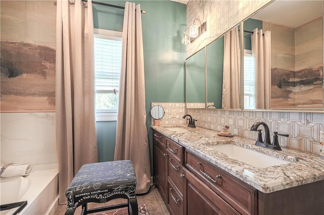 bathroom featuring double vanity, decorative backsplash, and a bath