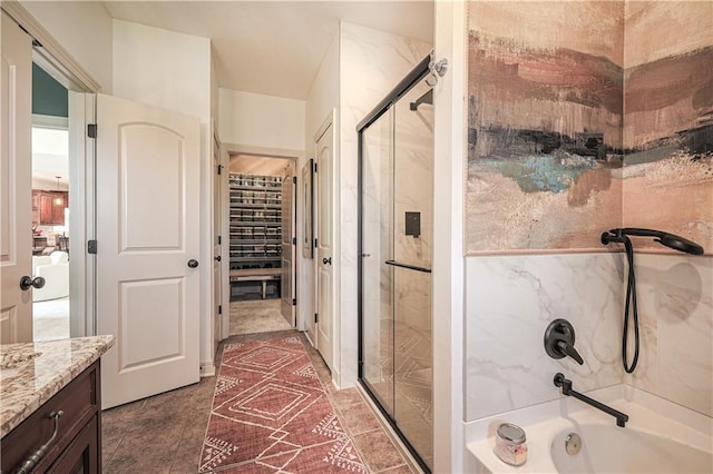 bathroom featuring enclosed tub / shower combo and vanity