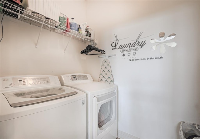 clothes washing area with washing machine and dryer