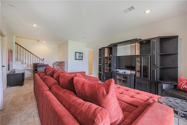 living area with light carpet, stairway, and recessed lighting