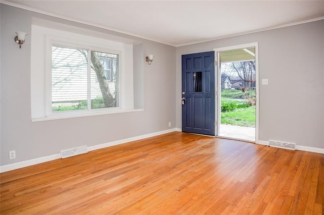 110 S Park Ave, Independence, MO 64050 - entryway featuring crown molding, light wood-style floors, and baseboards
