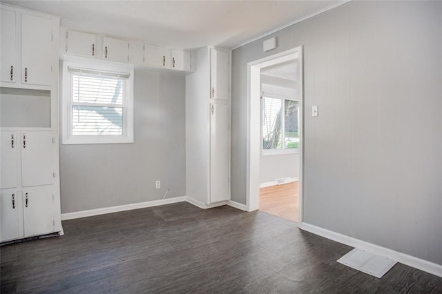 110 S Park Ave, Independence, MO 64050 - empty room featuring dark wood-style floors and baseboards