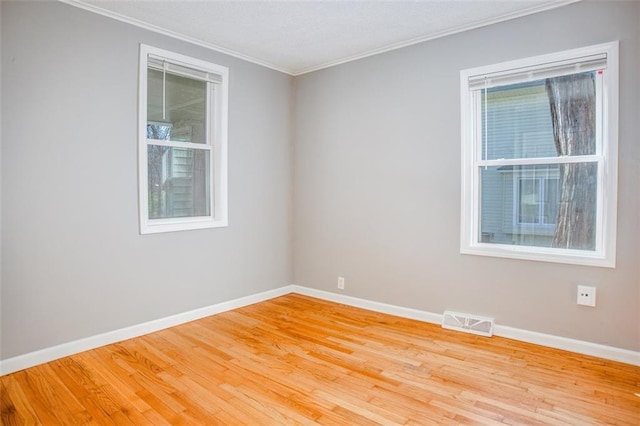 110 S Park Ave, Independence, MO 64050 - spare room with crown molding, light wood-style floors, and baseboards