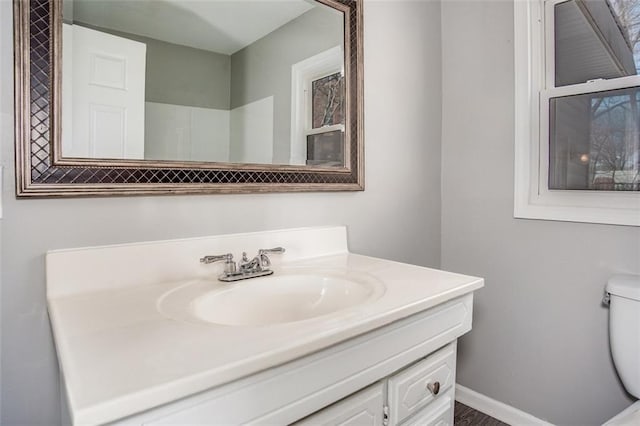 110 S Park Ave, Independence, MO 64050 - bathroom featuring vanity, toilet, and baseboards