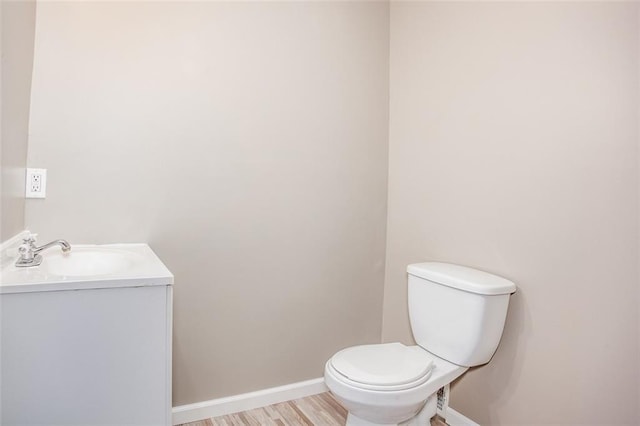 110 S Park Ave, Independence, MO 64050 - half bath with vanity, toilet, baseboards, and wood finished floors