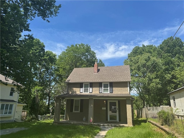 110 S Park Ave, Independence, MO 64050 - view of front of house with stucco siding, a porch, a chimney, and roof with shingles