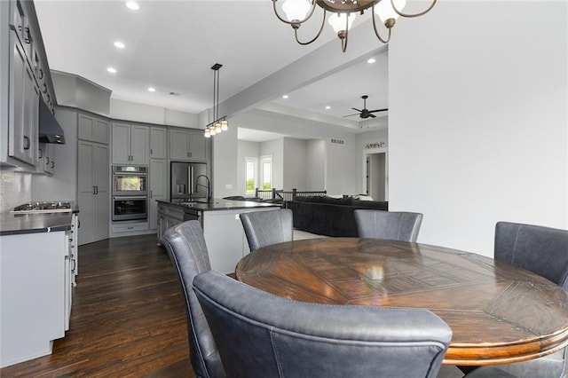 28897 Hackberry Cir, Paola, KS 66071 - dining area with recessed lighting, dark wood finished floors, ceiling fan, and a chandelier