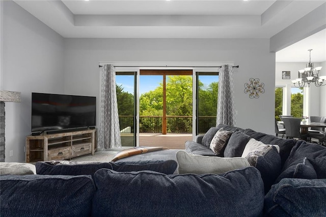 28897 Hackberry Cir, Paola, KS 66071 - living area featuring a chandelier, plenty of natural light, and a raised ceiling