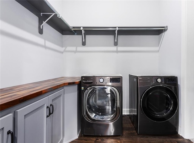 28897 Hackberry Cir, Paola, KS 66071 - washroom featuring separate washer and dryer, dark wood-style flooring, and cabinet space
