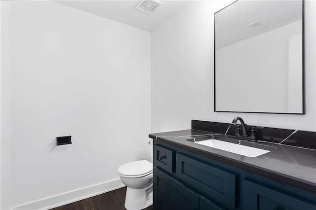 28897 Hackberry Cir, Paola, KS 66071 - bathroom featuring wood finished floors, vanity, toilet, and baseboards