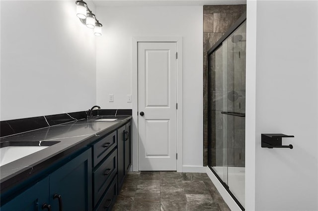 28897 Hackberry Cir, Paola, KS 66071 - bathroom featuring a stall shower, double vanity, and baseboards