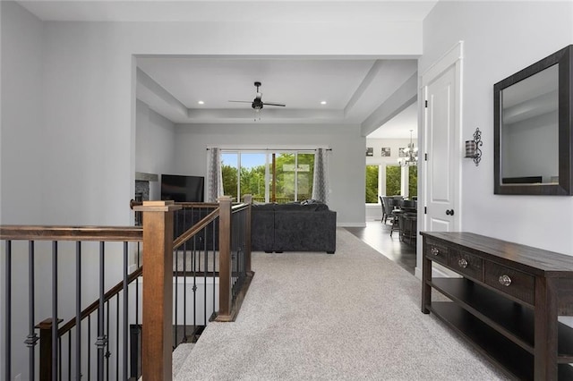 28897 Hackberry Cir, Paola, KS 66071 - carpeted living room with ceiling fan, a tray ceiling, a chandelier, and recessed lighting