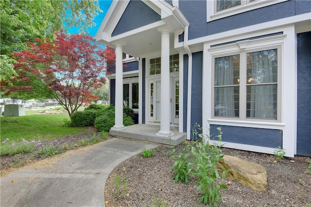 6330 N Nevada Ave, Parkville, MO 64152 - doorway to property featuring stucco siding and a porch