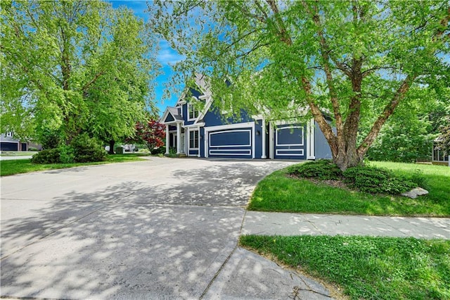 6330 N Nevada Ave, Parkville, MO 64152 - view of property hidden behind natural elements featuring driveway and an attached garage