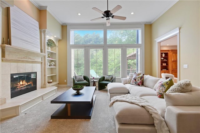 6330 N Nevada Ave, Parkville, MO 64152 - carpeted living room featuring crown molding, a fireplace, a ceiling fan, built in shelves, and recessed lighting