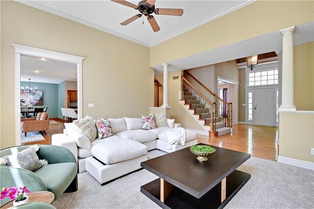6330 N Nevada Ave, Parkville, MO 64152 - living room featuring ornate columns, a chandelier, crown molding, a ceiling fan, and stairway