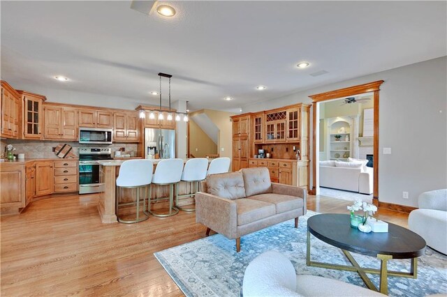 6330 N Nevada Ave, Parkville, MO 64152 - living room with light wood-style floors, recessed lighting, a ceiling fan, and baseboards
