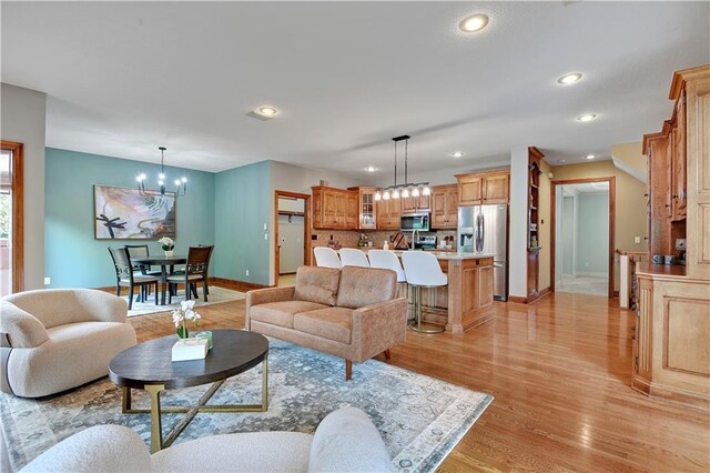 6330 N Nevada Ave, Parkville, MO 64152 - living room featuring a chandelier, baseboards, recessed lighting, and light wood finished floors