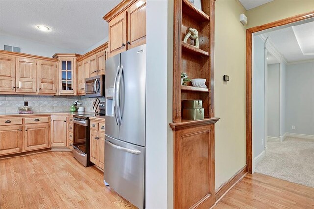 6330 N Nevada Ave, Parkville, MO 64152 - kitchen with stainless steel appliances, open shelves, tasteful backsplash, glass insert cabinets, and crown molding