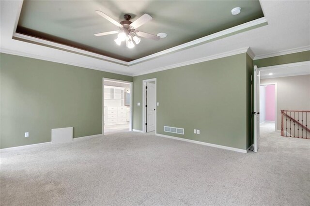 6330 N Nevada Ave, Parkville, MO 64152 - carpeted empty room with a raised ceiling, crown molding, a ceiling fan, and baseboards
